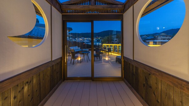 A covered outdoor seating area with a view of the city at dusk. - Terrace Kiyomizu Kyoto (Kyoto)
