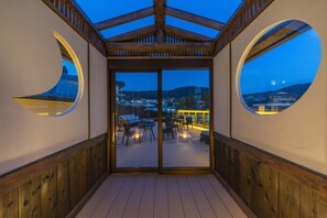 A covered outdoor seating area with a view of the city at dusk. - Terrace Kiyomizu Kyoto (Kyoto)