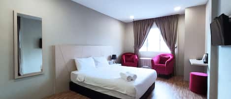 Deluxe Room | Desk, laptop workspace, blackout curtains, iron/ironing board