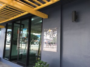 A building entrance with a sign reading "HUB 53" and a notice for "POLICE HOUR 8am-8pm 2 days a week". - Hub53 Coworking & Coliving Space (Chiang Mai)