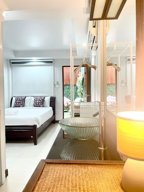 A modern bedroom with a bed, a hanging chair, and a large mirror. - Hub53 Coworking & Coliving Space (Chiang Mai)