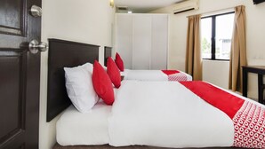 A hotel room with a bed, a wardrobe, a window with curtains, and an air conditioning unit. - Hotel O 91 @ Bukit Mewah (Kajang)