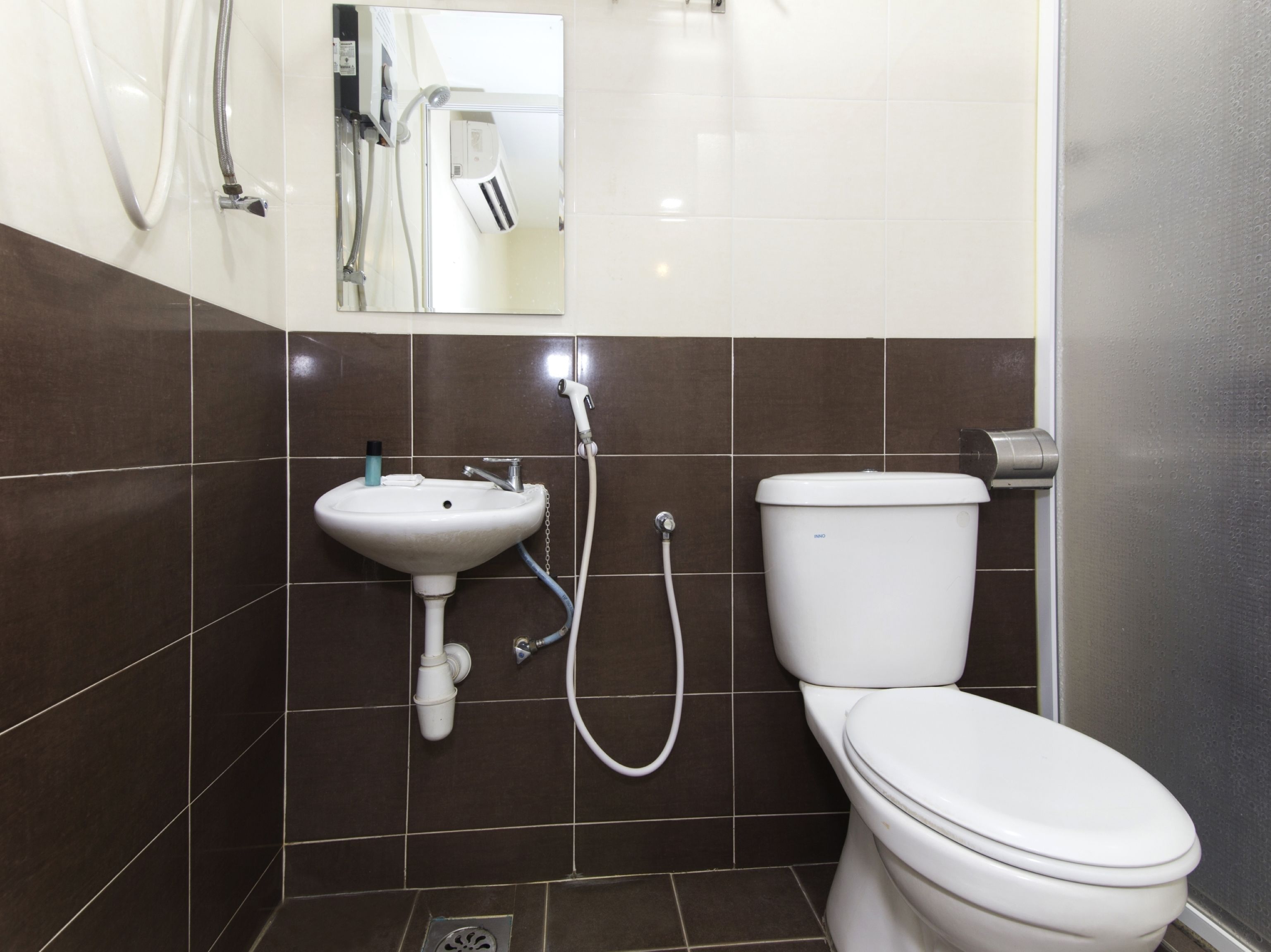 A bathroom with a sink, toilet, and shower.