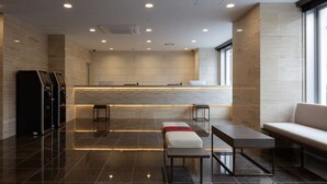 A modern lobby with a reception desk, seating area, and a large window providing natural light. - Center Hotel Narita 2 R51 (Narita)