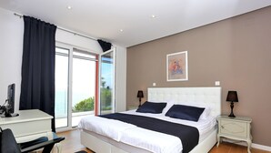 A modern bedroom with a large bed, a desk, and a chair. - Villa With Private Pool (Kukljica)