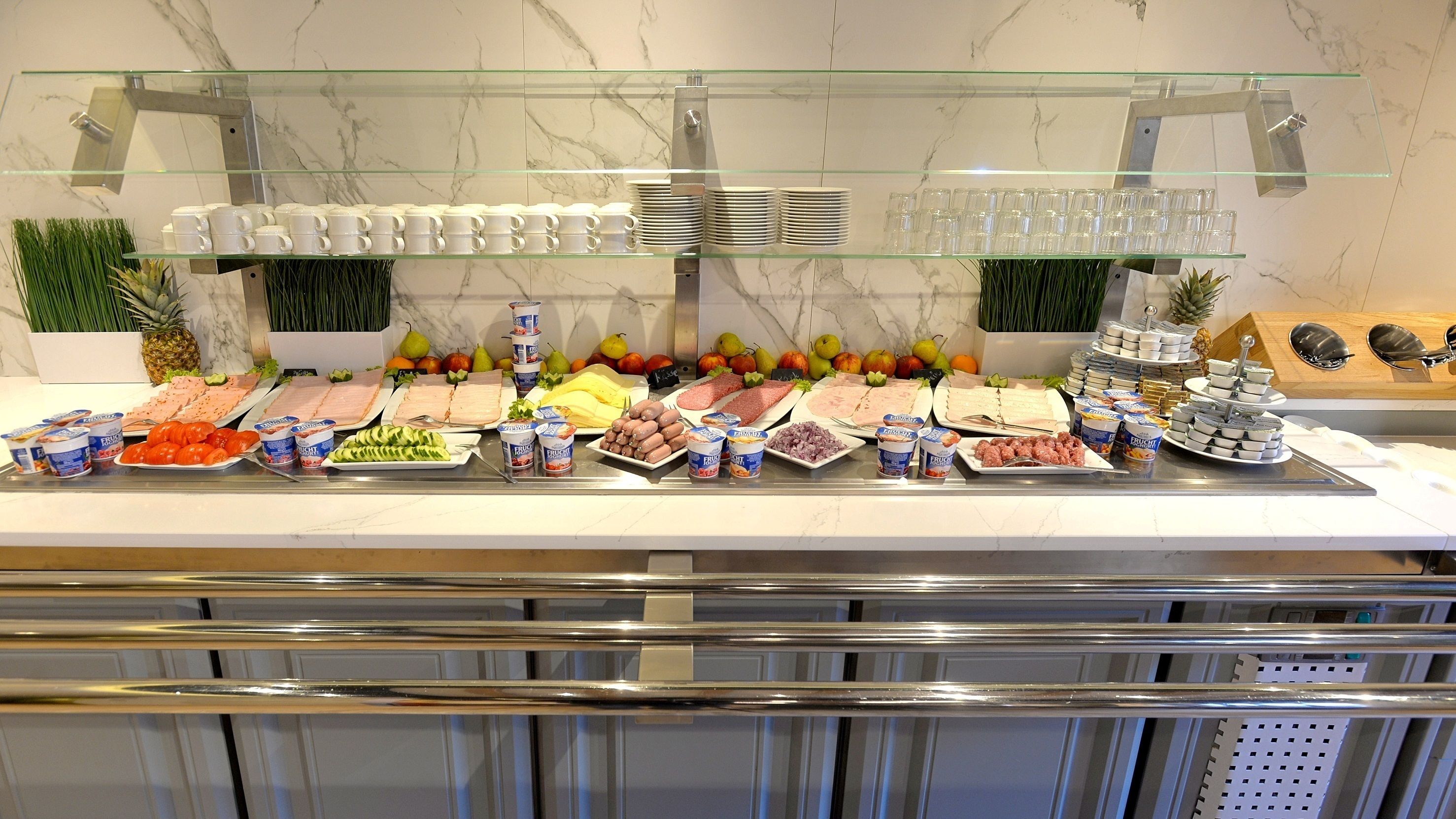 A buffet with various food items and drinks.