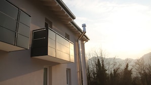 A modern building with a flat roof, large windows, and a visible chimney. - Pove 2.4 Hotel (Pove del Grappa)