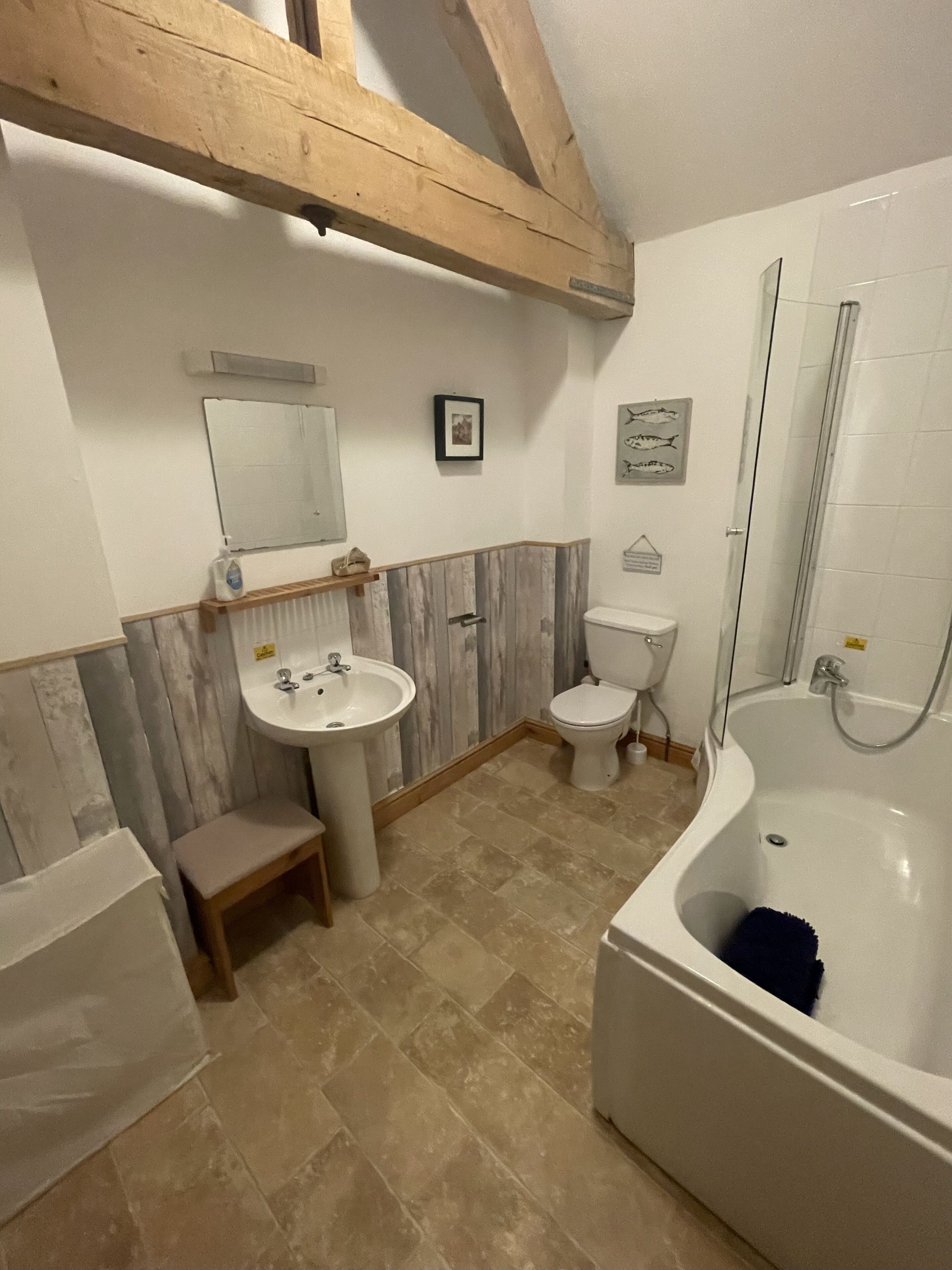 A bathroom with a sink, toilet, and bathtub.