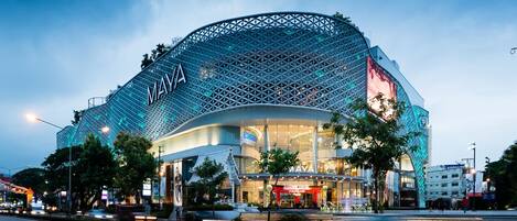 A modern building with a distinctive geometric facade and the name 'MAYA' prominently displayed.