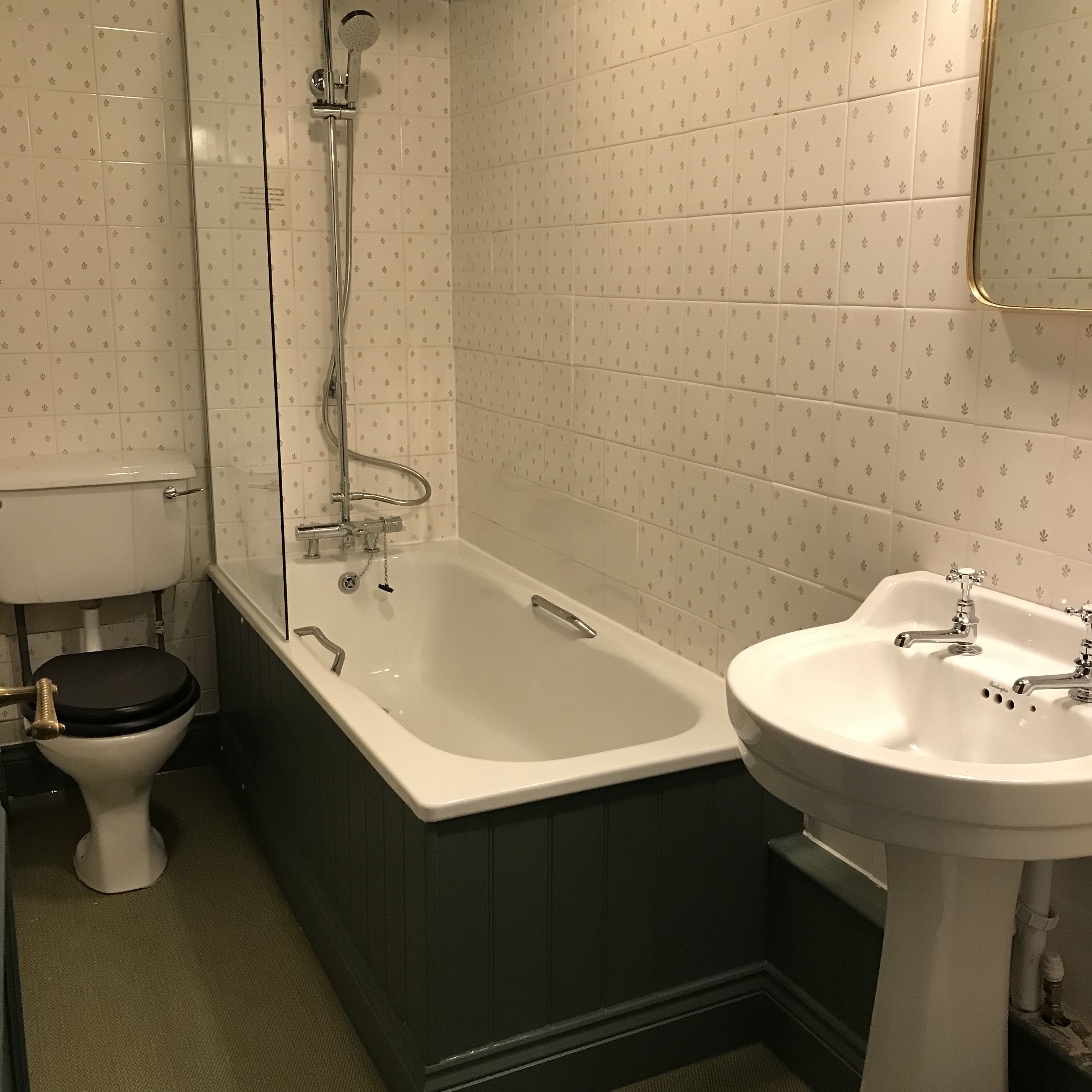 A bathroom with a toilet, a bathtub, and a sink.