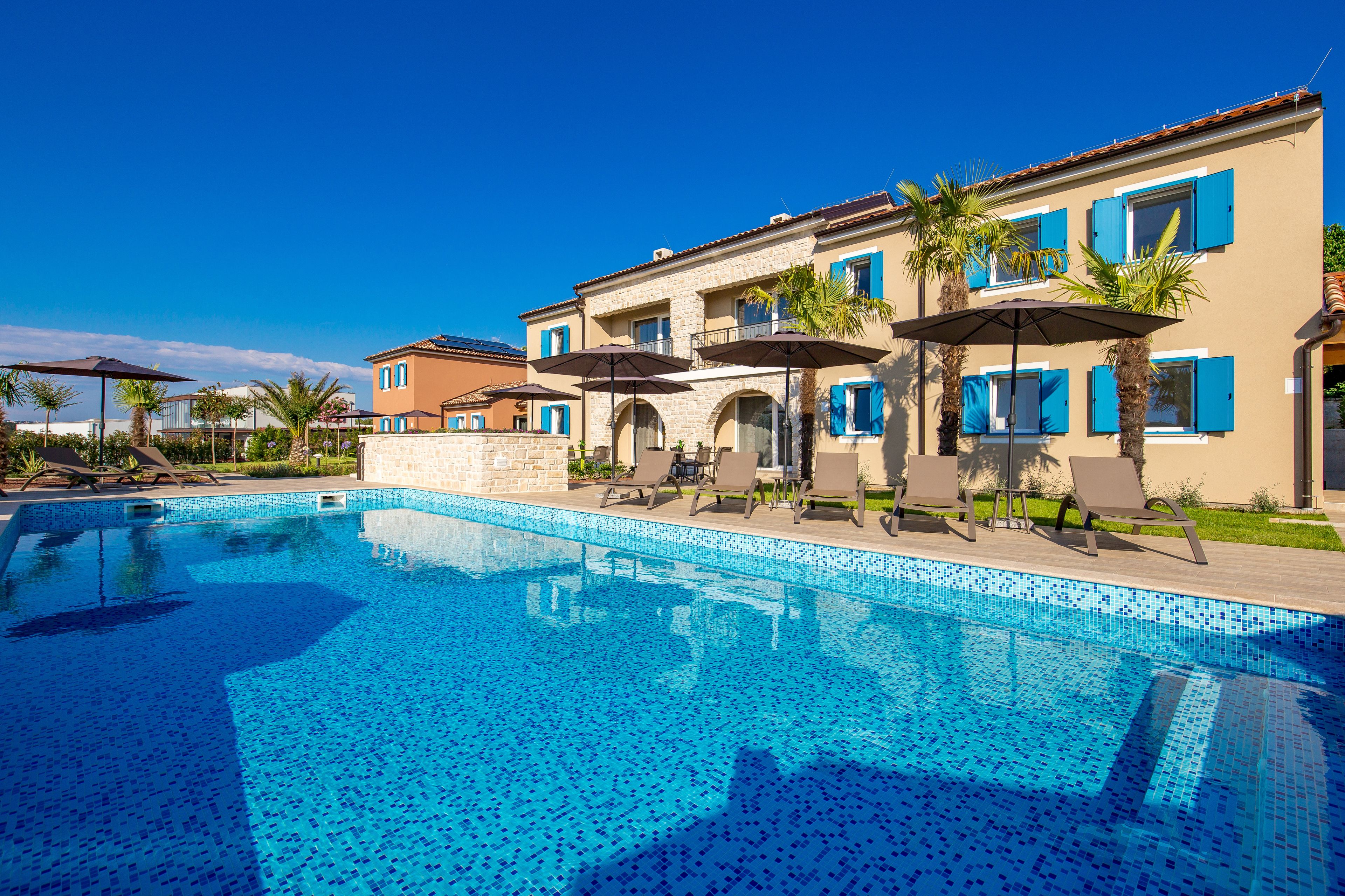 Seasonal outdoor pool, open 8:00 AM to 8:00 PM, pool umbrellas