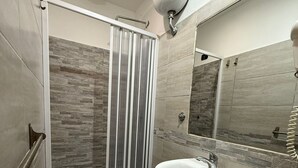 A modern bathroom with a shower, toilet, and sink. - Hola Roma (Rome)