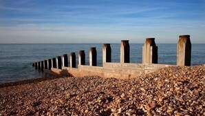 A rocky beach with a concrete sea defense structure. - Gyves Guest House (Eastbourne)