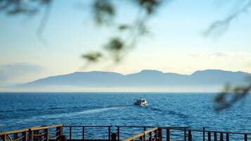 A boat on a calm sea with distant mountains.