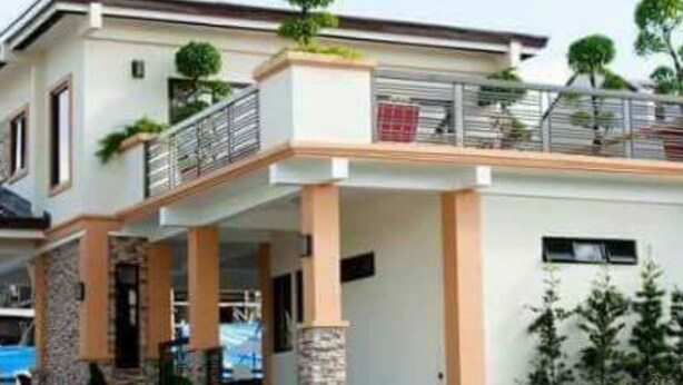 A modern two-story house with a covered patio, a swimming pool, and a well-maintained lawn. - 2 Bedroom Villa by AP at Tagaytay Hampton Villa (Tagaytay)