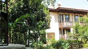 A two-story building with a balcony and a stone staircase leading to the entrance. - Defne Pansiyon (Marmaris)