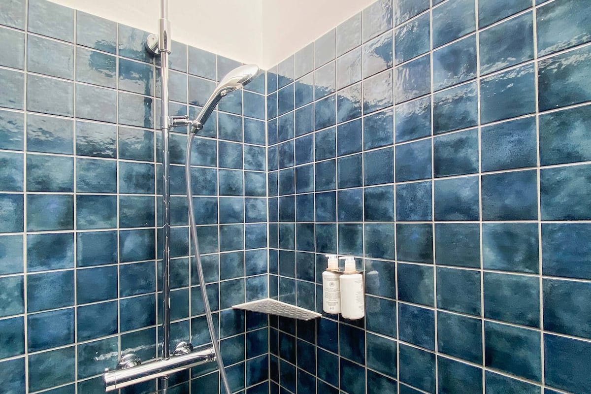 rainfall showerhead, eco-friendly toiletries, hair dryer, towels