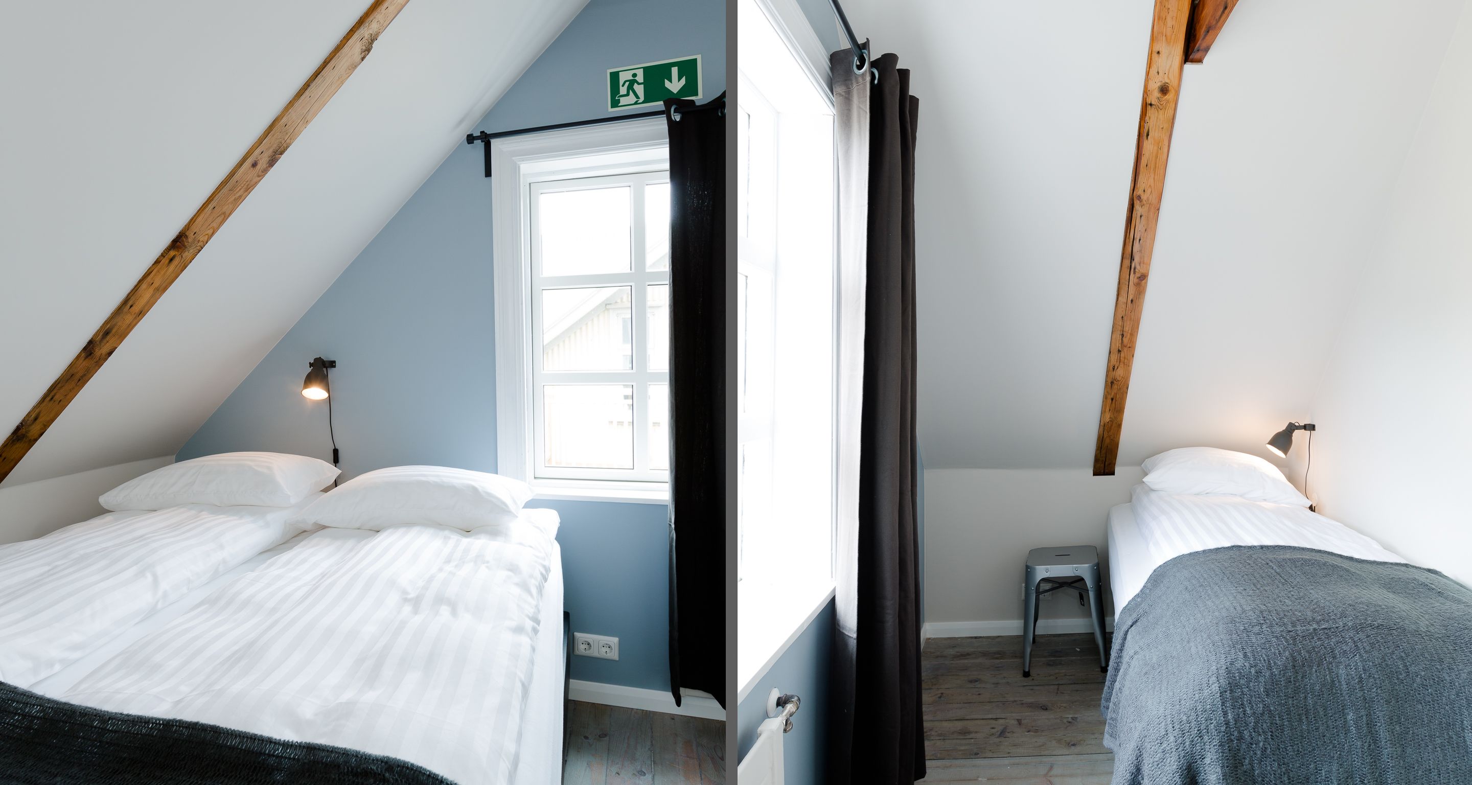 A small, cozy room with two beds, a window, and a wooden ceiling.