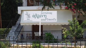 A sign for 'THA apartments' with a contact number.