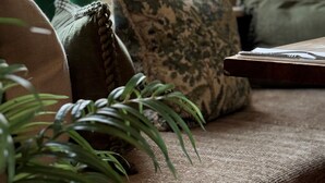 A cozy seating area with a sofa, cushions, and a lamp. - Scarborough Hill Country Inn (North Walsham)
