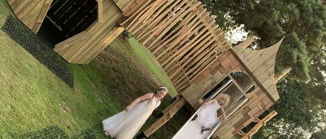 A wedding scene with a wooden structure in the background.