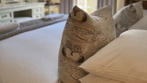 A bedroom with a bed, pillows, a dresser, a mirror, and a window with curtains. - Scarborough Hill Country Inn (North Walsham)