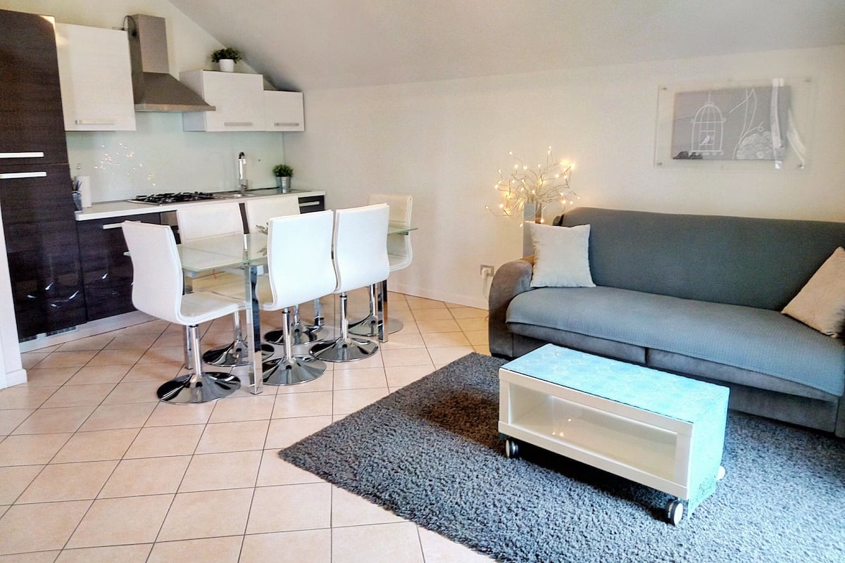 A compact living space with a kitchenette, dining area, and seating area.