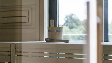A kitchen counter with a wooden utensil holder and a metal spoon.