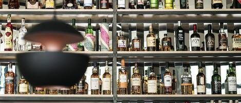 A bar with shelves of various liquor bottles.
