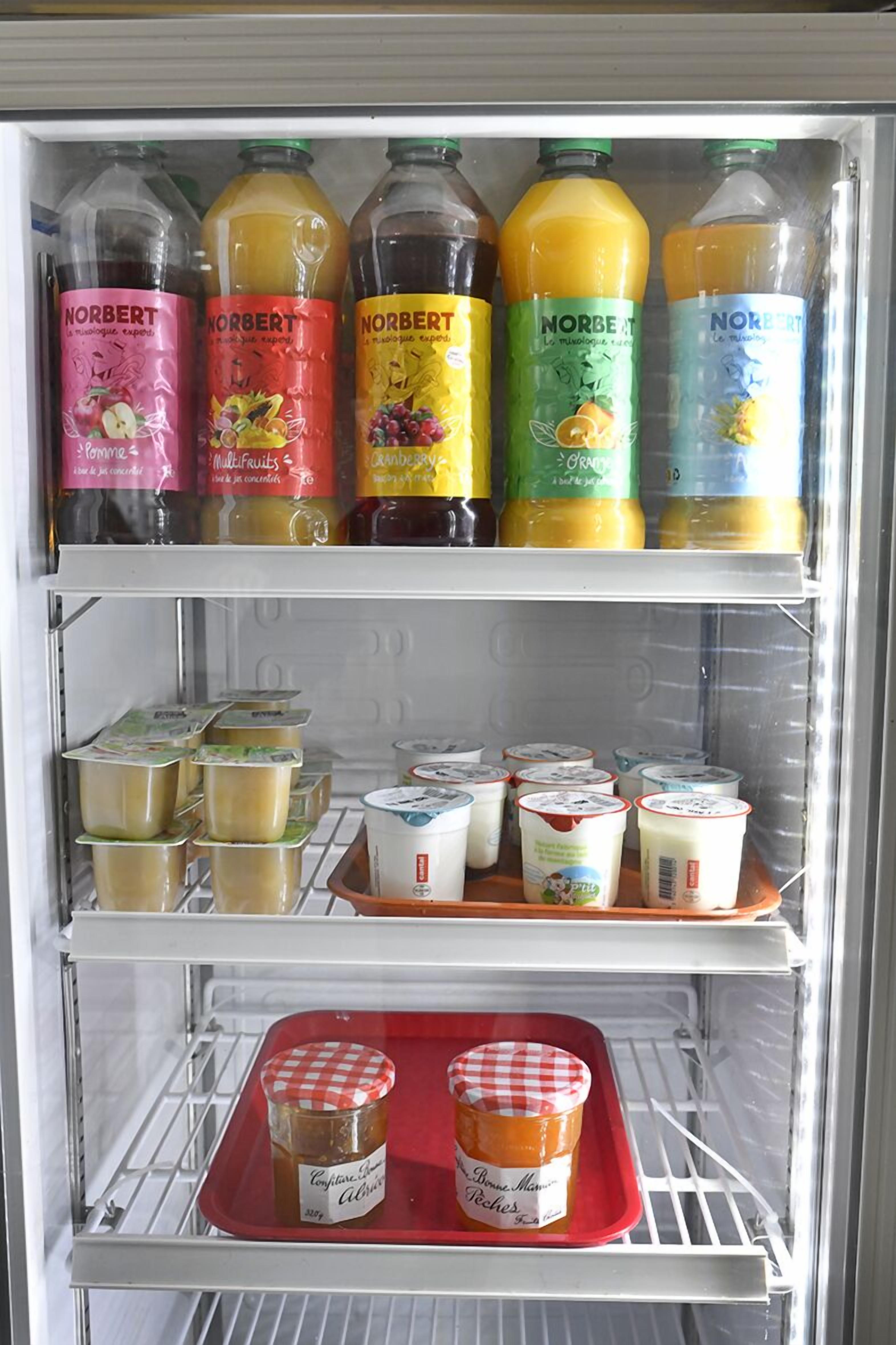 A refrigerator stocked with various beverages and food items.