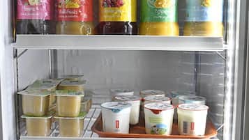 A refrigerator stocked with various beverages and food items.