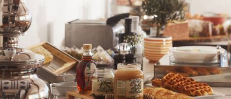 A breakfast buffet with various food items and condiments.