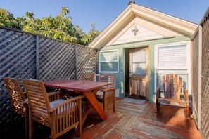 Outdoor furniture table and 4 chairs with wagon wheel wood rocking chair.