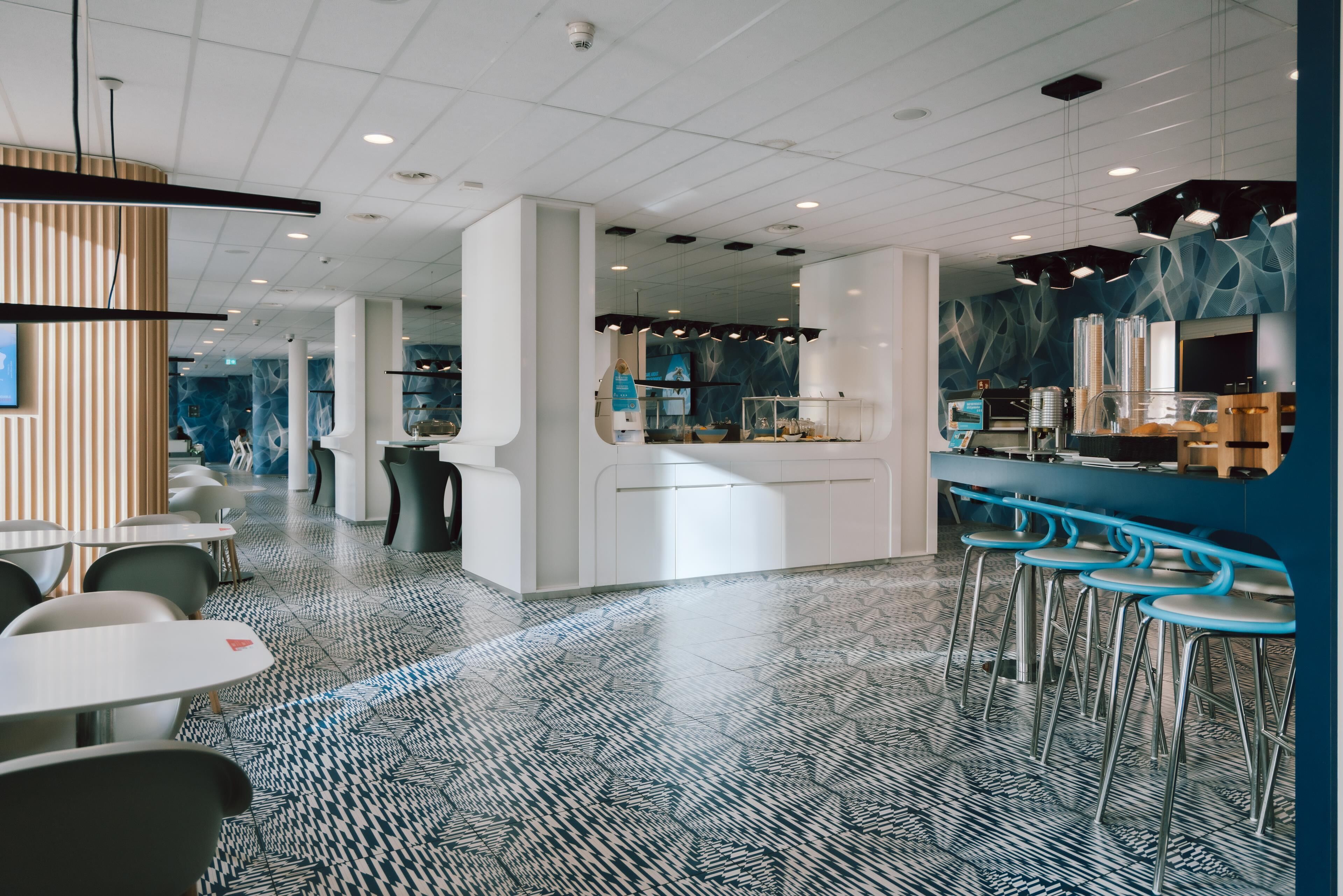 Een modern interieur met een bar, zitplaatsen en een vloer met patroon.
