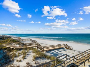 Walk along the beach on a wooden boardwalk with ocean views.