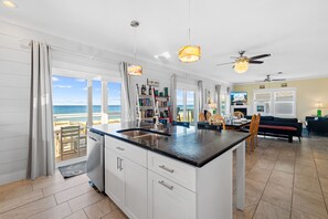 Enjoy ocean views from this spacious living space with a central island kitchen and dining area.
