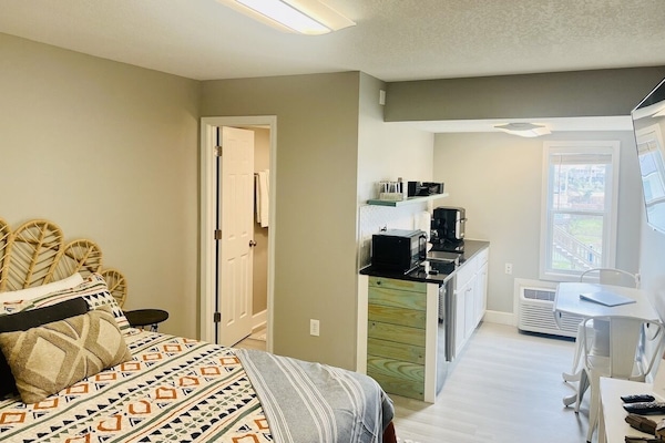 This studio condo is furnished with a queen bed, futon, and a flat screen tv.