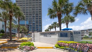 A building with a sign reading "Ocean Forest Plaza" and a number "5523". - COUPLES ROMANTIC GETAWAY, OCEANFRONT, HIGH-END DECOR, ADJUST. KING, FREE PARKING (Myrtle Beach)