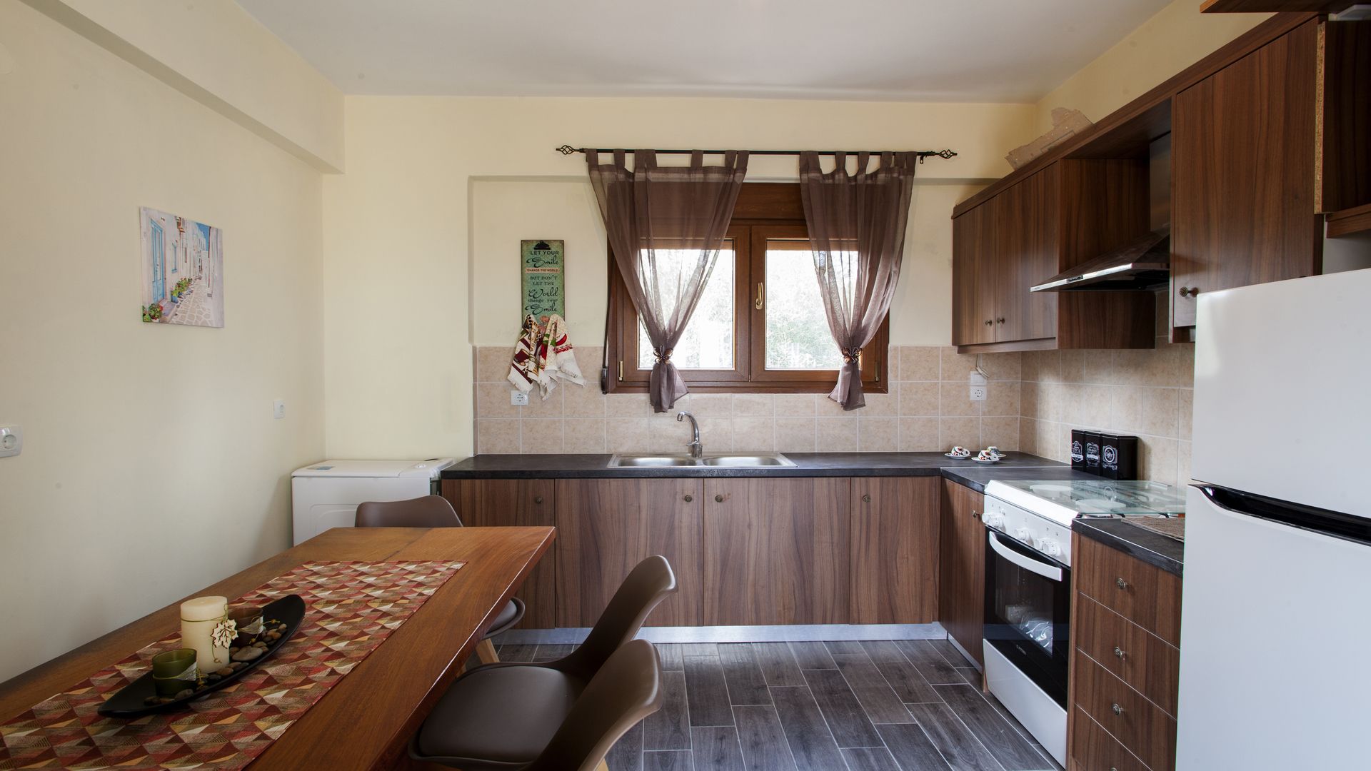A compact kitchen with wooden cabinets, a built-in oven, and a sink.
