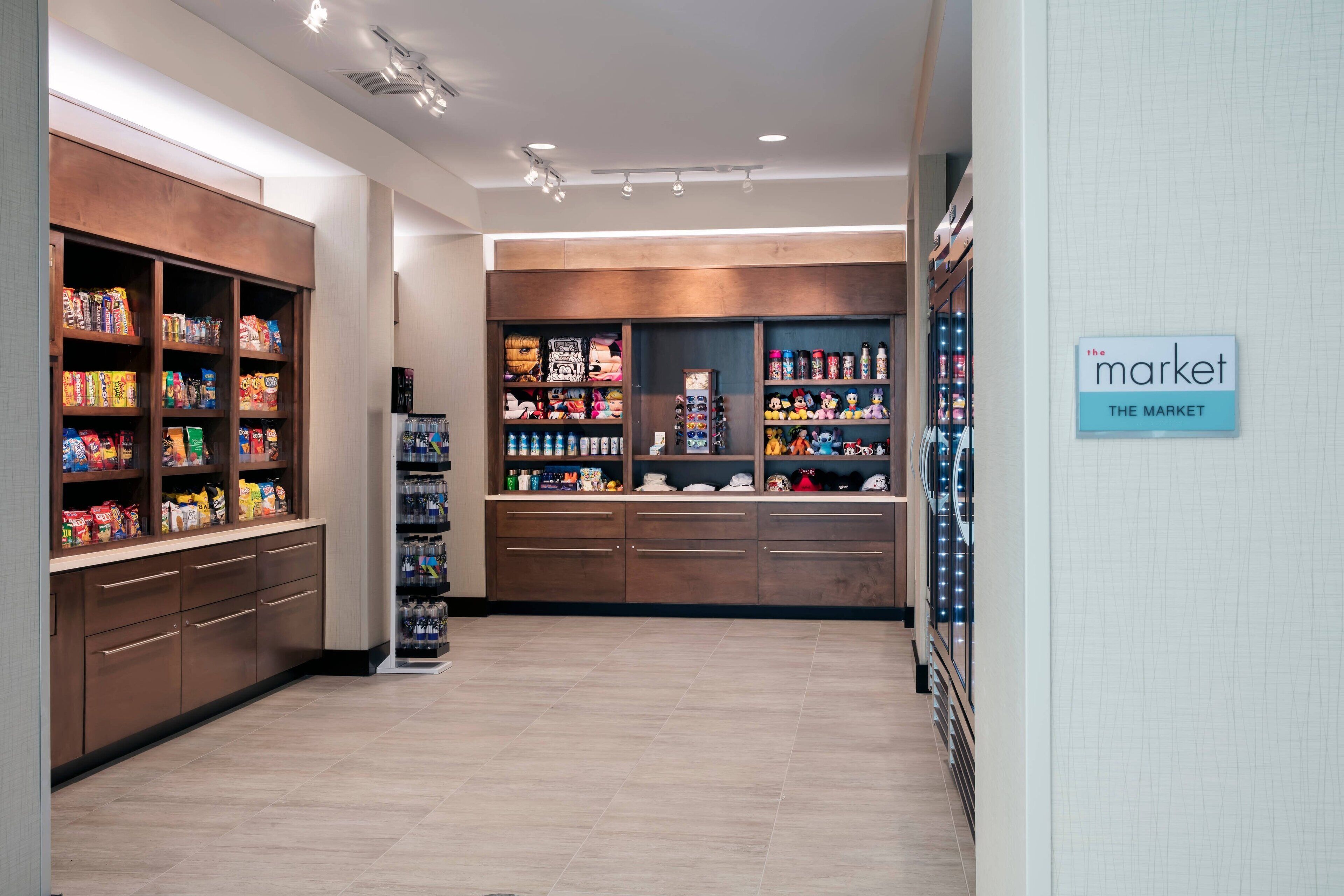 A clean, well-lit store with shelves stocked with snacks and beverages.