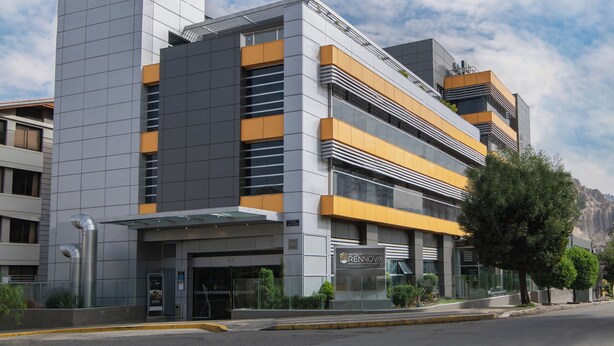 A modern hotel with a multi-story structure, large windows, and a prominent entrance.