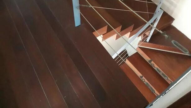 A wooden staircase with metal railings. - Casa Pinos V (Mazatlán)