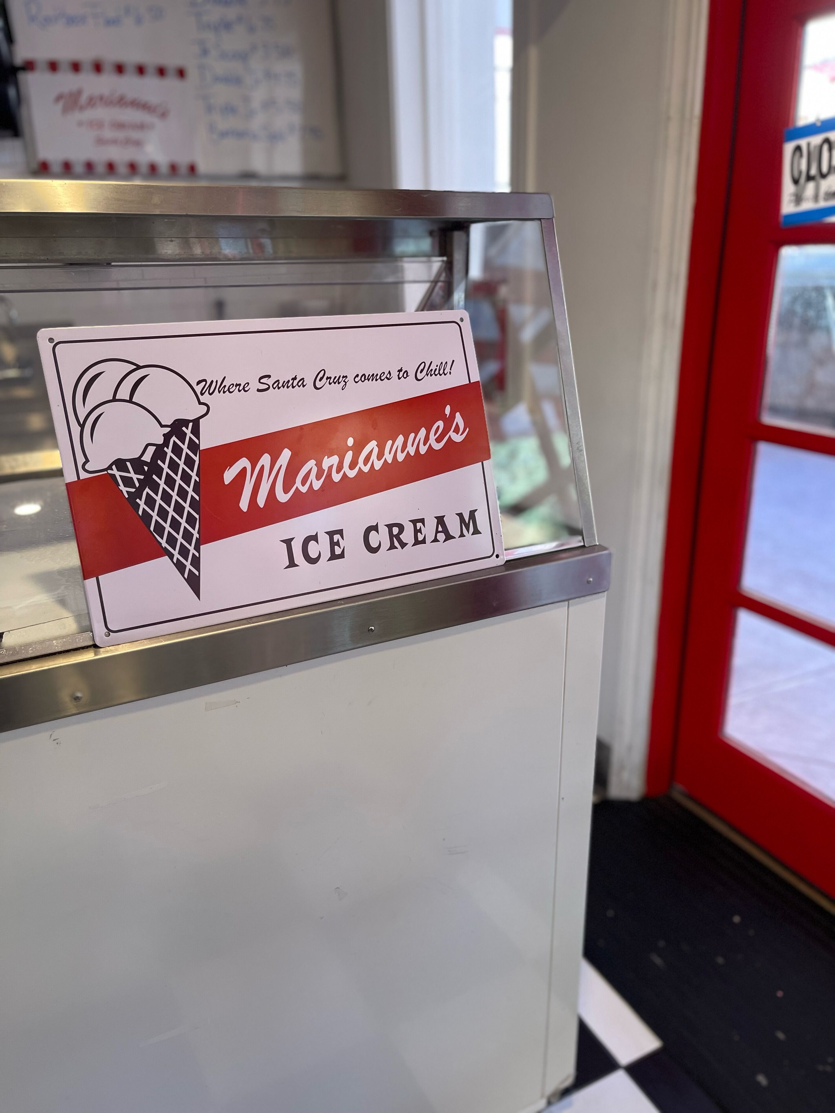 A sign for Marianna's Ice Cream with a waffle cone graphic.