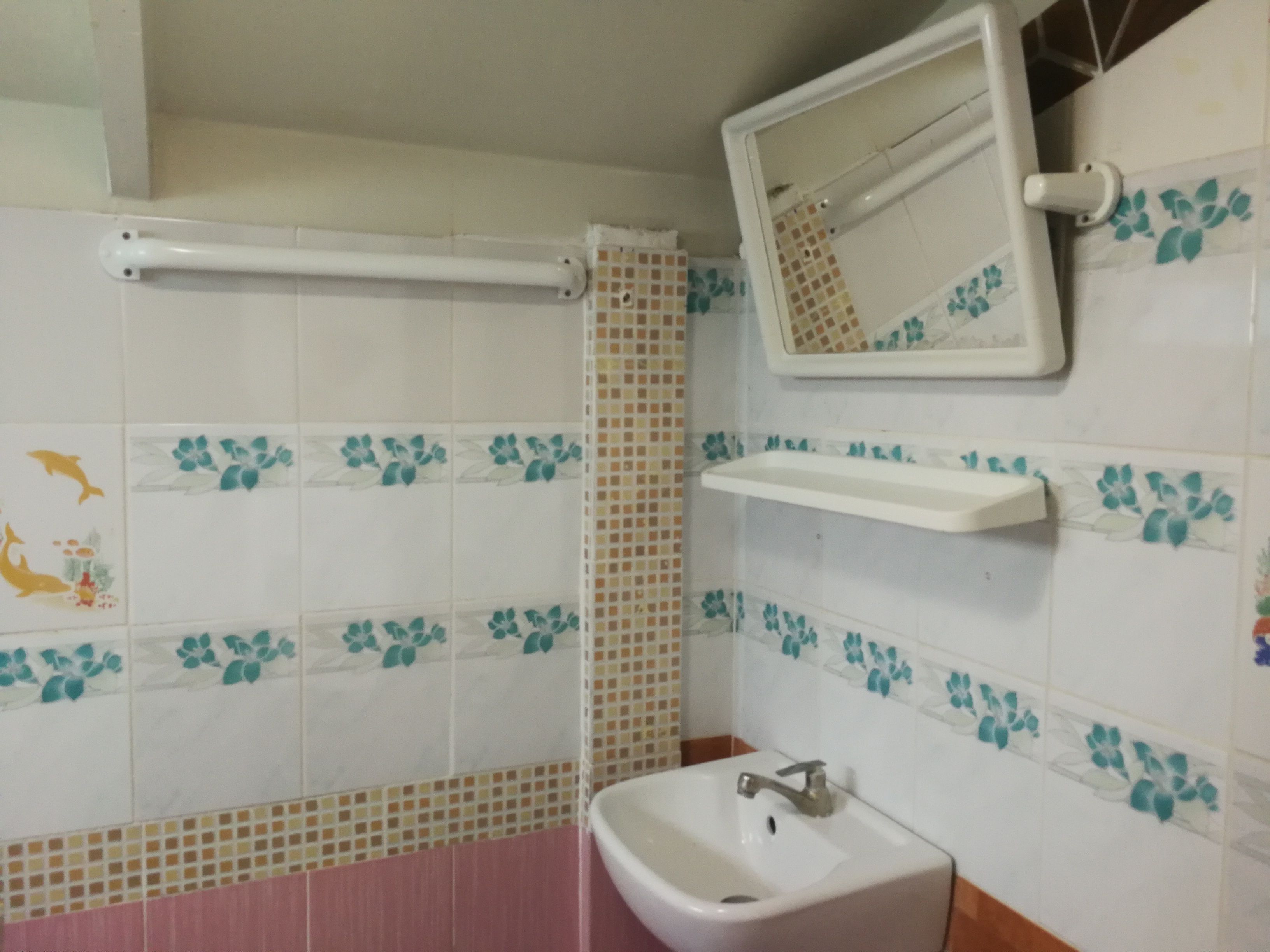 A bathroom with a sink, mirror, and a towel rack.