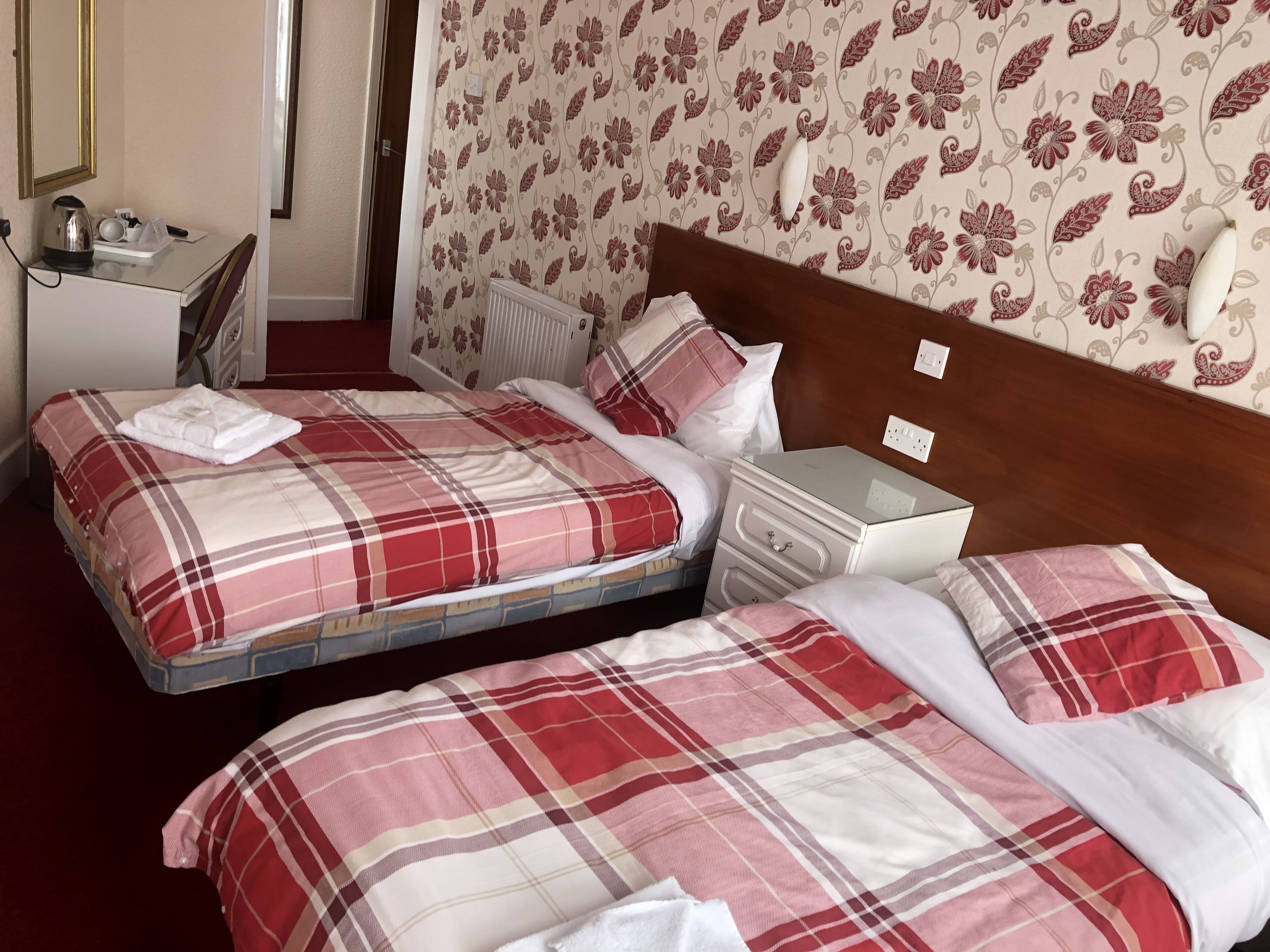 Desk, iron/ironing board, bed sheets