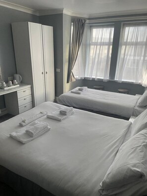 Family Room | Desk, iron/ironing board, bed sheets