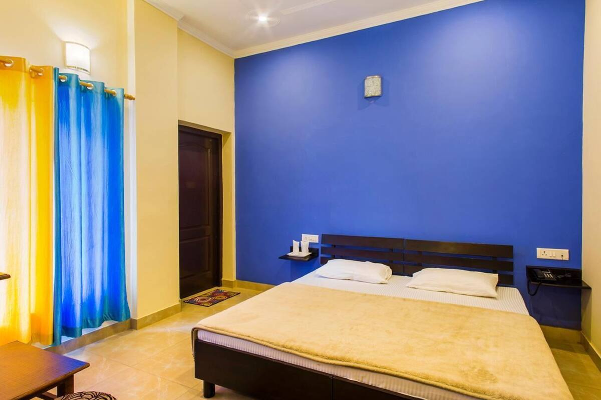A bedroom with a bed, bedside table, and a nightstand.