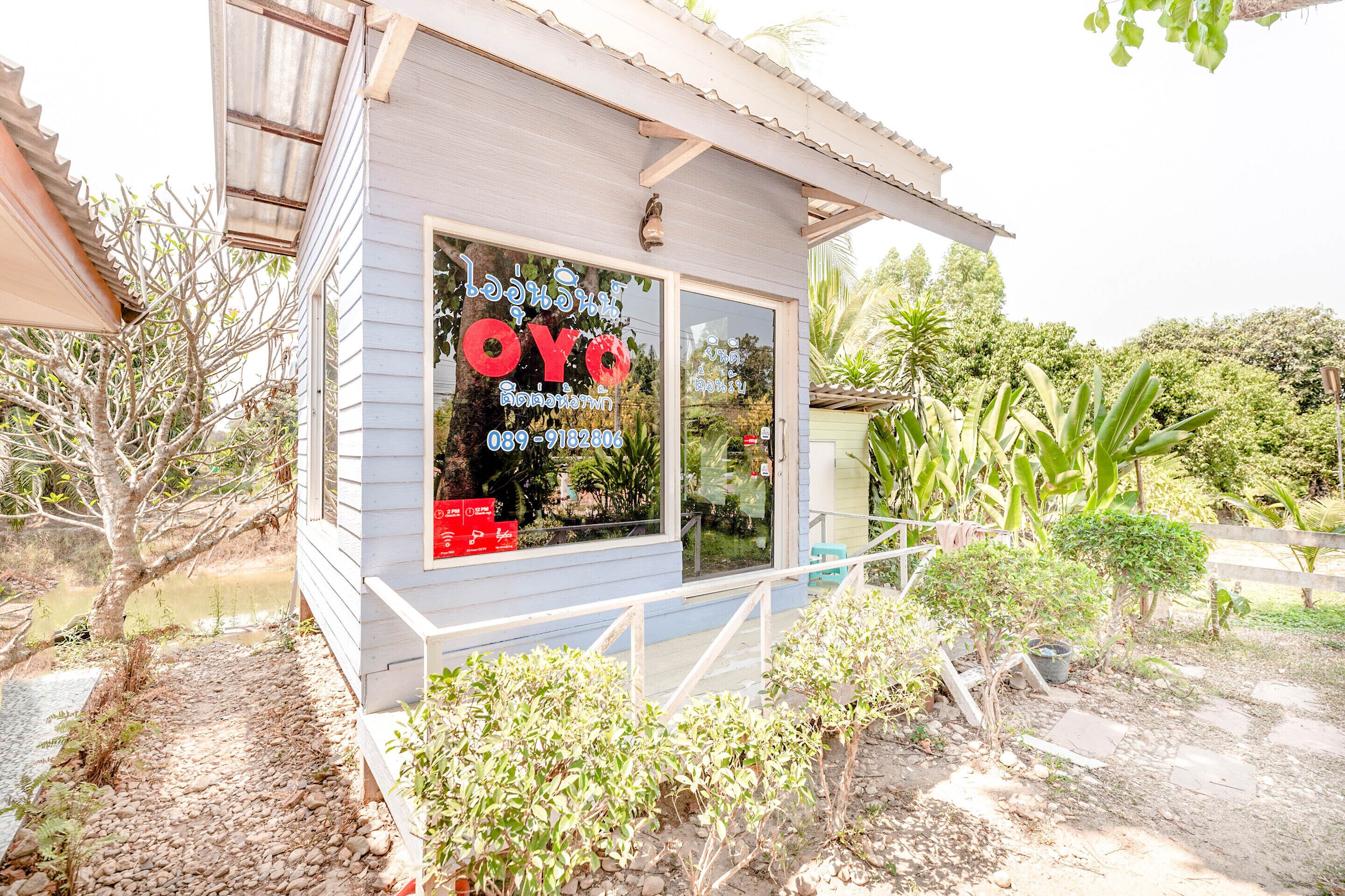 A small building with a sign that reads "OYO" and a phone number.