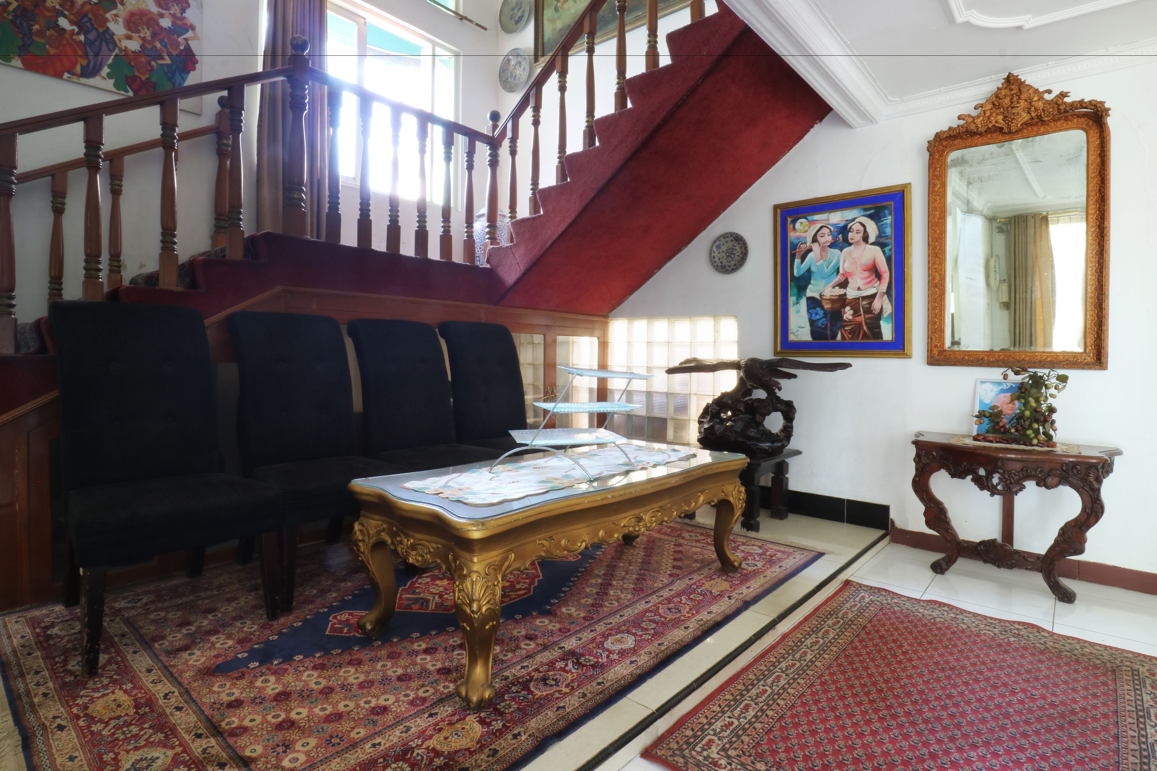 A spacious living area with a staircase, a coffee table, and a sofa.