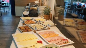 A buffet with various food items including salads, sliced meats, and vegetables. - Wydma Resort (Trzebiatow)